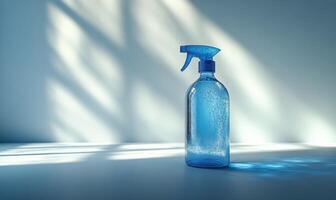 A blue spray bottle with a sprayer on top photo