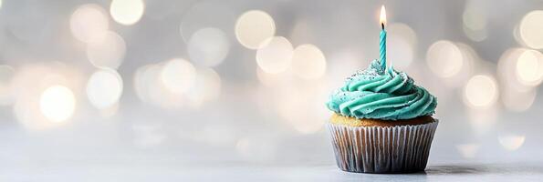 A cupcake with a single candle on top photo