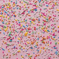 Sprinkles on a pink background photo