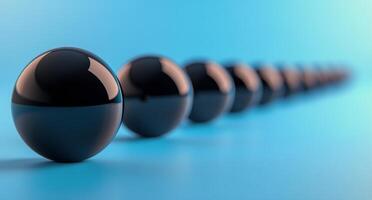 A row of black balls on a blue background photo