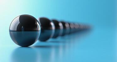 A row of black spheres on a blue background photo