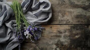 Lavender flowers on a cloth on a wooden background photo