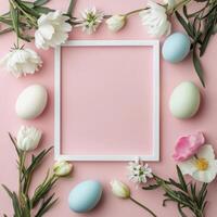 Easter eggs and flowers on pink background with white frame photo