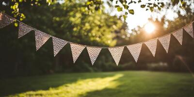 A bunting banner hanging from a tree in the sun photo