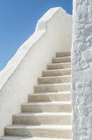 A white stone stairway leading to a white building photo