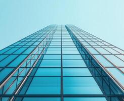 A tall building with glass windows and a blue sky photo