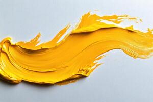 A yellow paint is being poured into a bowl photo