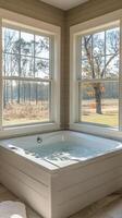 A large tub sitting in front of a window photo