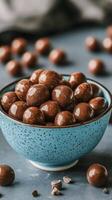 Chocolate covered almonds in a bowl photo