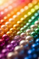 A rainbow of colored pearls on a black background photo