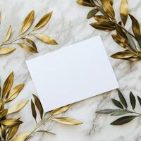 Blank card on marble background with gold leaves photo