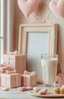 Pink gift boxes and a glass of milk on a table photo