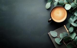 Coffee cup and eucalyptus leaves on black background photo