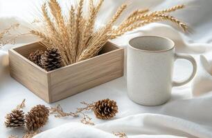 A cup of coffee and pine cones on a bed photo