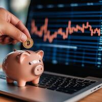 Bitcoin piggy bank on laptop screen photo