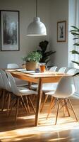 A dining room table with white chairs and a potted plant photo