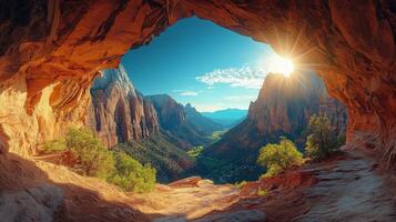 A view of the sun shining through a cave in the mountains photo