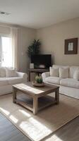 A living room with white couches and a coffee table photo