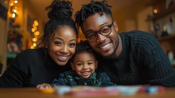 A black couple and their child are smiling at the camera photo