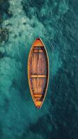 An aerial view of a wooden boat floating in the water photo