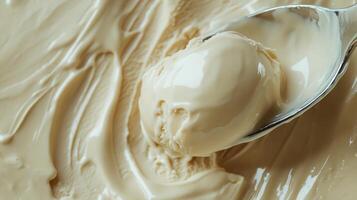 A spoon with a scoop of ice cream in a bowl photo