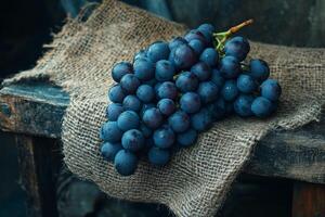 A bunch of grapes sitting on a wooden table photo