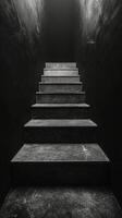 Black and white photo of stairs in dark room