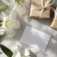 Gift box with white lilies and card on grey background photo