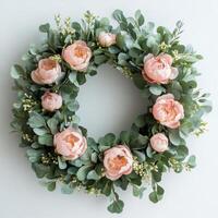 Wreath with pink peonies and eucalyptus leaves on white background photo