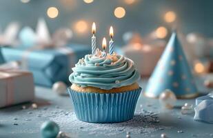 A blue cupcake with three lit candles on top photo
