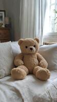 A teddy bear sitting on a bed photo