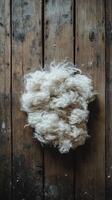 A pile of white wool on a wooden floor photo