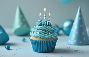 A cupcake with blue frosting and candles photo