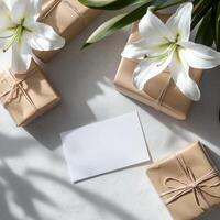 Gift boxes with white lilies and blank card on white background photo