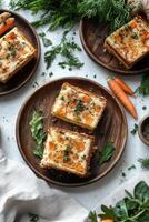 Carrot and cheese quiche on wooden plates photo