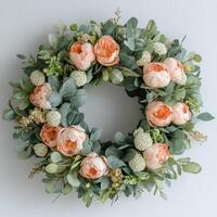 A wreath with peach peonies and eucalyptus leaves photo