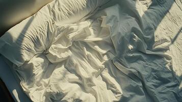 A bed with a white sheet photo