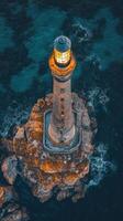 An aerial view of a lighthouse on a rocky island photo
