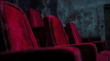 Red velvet chairs in a dark room photo