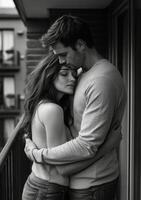 A black and white photo of a couple embracing