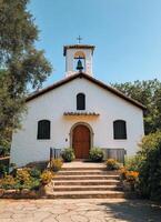 A white church with a bell tower photo
