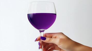 A person holding a glass of purple wine photo