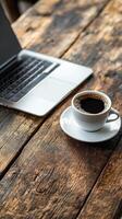 Coffee and laptop on wooden table photo