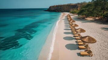 A beach with thatched umbrellas and chairs photo