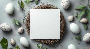 Easter egg with white paper and green leaves on grey background 3d top view photo
