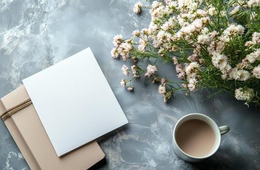 Blank notebook, coffee cup and flowers on marble background photo
