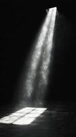 A light shining through a window in a dark room photo