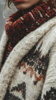 A woman wearing a sweater and scarf photo