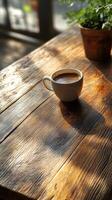 A coffee cup sitting on a wooden table photo