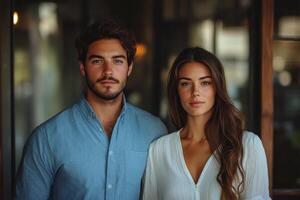 A man and woman standing in front of a window photo